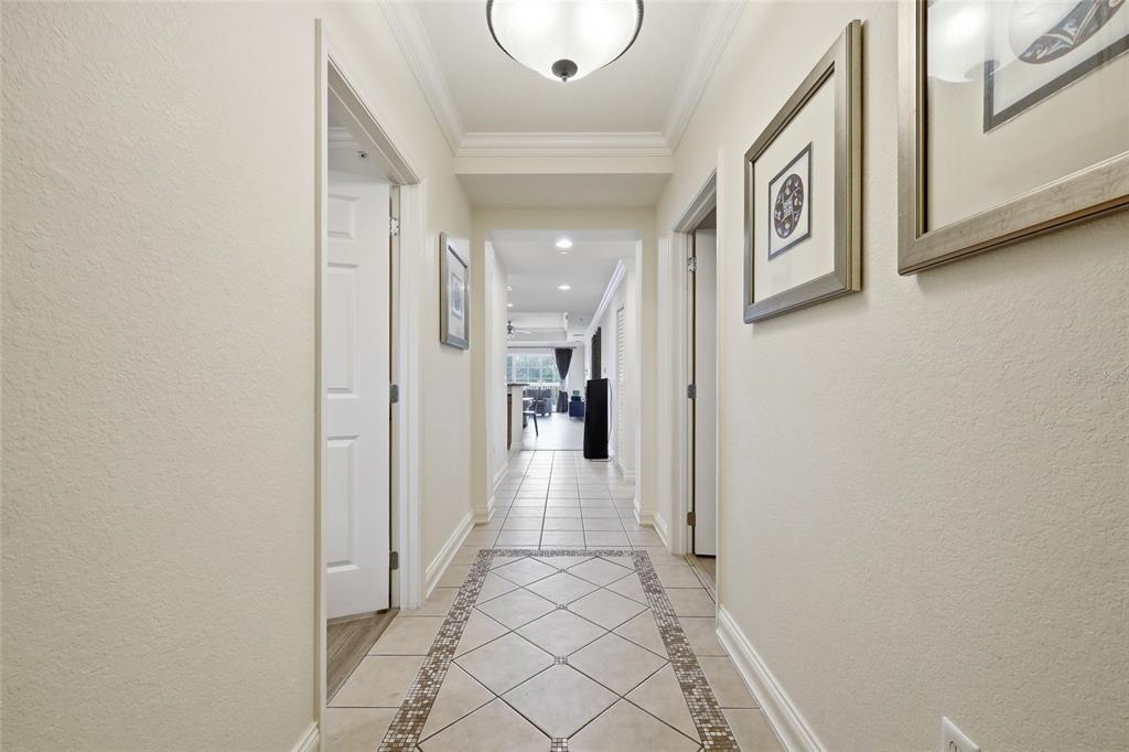 An aerial view shows three multi-story apartment buildings surrounded by a golf course and trees — 7612 CABANA COURT UNIT 202, REUNION, FL