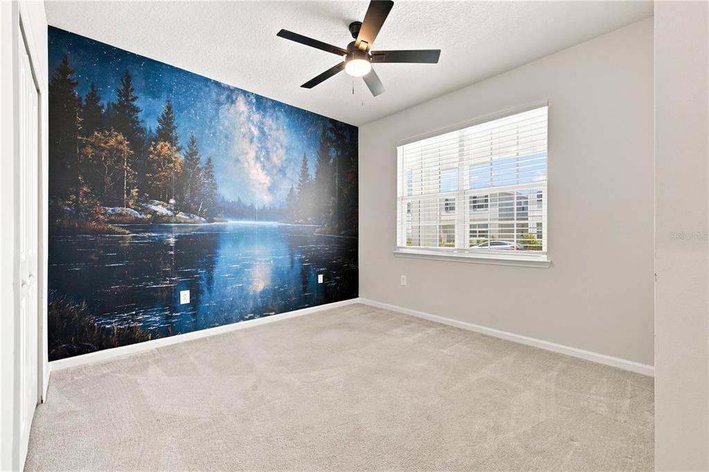 A bedroom features a large forest and night sky mural on one wall and carpet — 3754 ISLE ROYAL PLACE, APOPKA, FL