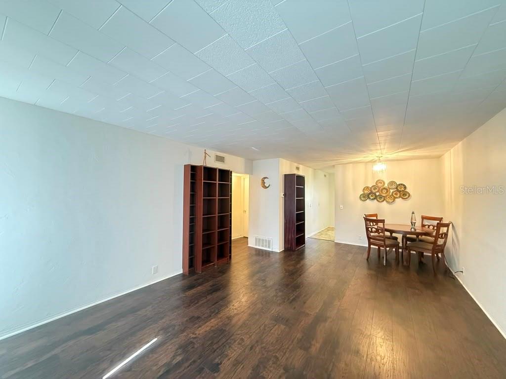 A bathroom features a white bathtub, a toilet, a vanity with a sink, and shelving — 4032 57TH STREET N UNIT 264, KENNETH CITY, FL