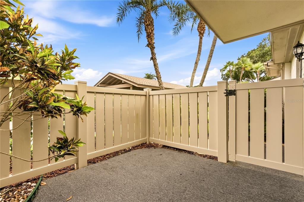 A living room with tile floors, a wooden coffee table, and an adjacent dining area — 260 MICHAELS CIRCLE, OLDSMAR, FL