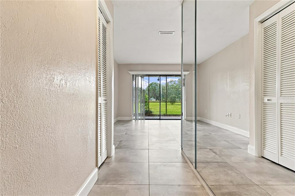 A living room features a large sectional sofa, a wooden coffee table, and sliding glass doors — 260 MICHAELS CIRCLE, OLDSMAR, FL