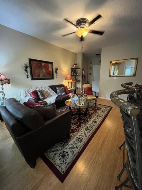 A living room features a dark leather sofa, a coffee table, and a ceiling fan — 1910 E PALM AVENUE UNIT 10303, TAMPA, FL