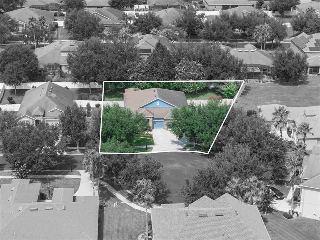 An aerial view of a single-story house with a shingled roof and two-car garage — 112 PECORRI COURT, AUBURNDALE, FL