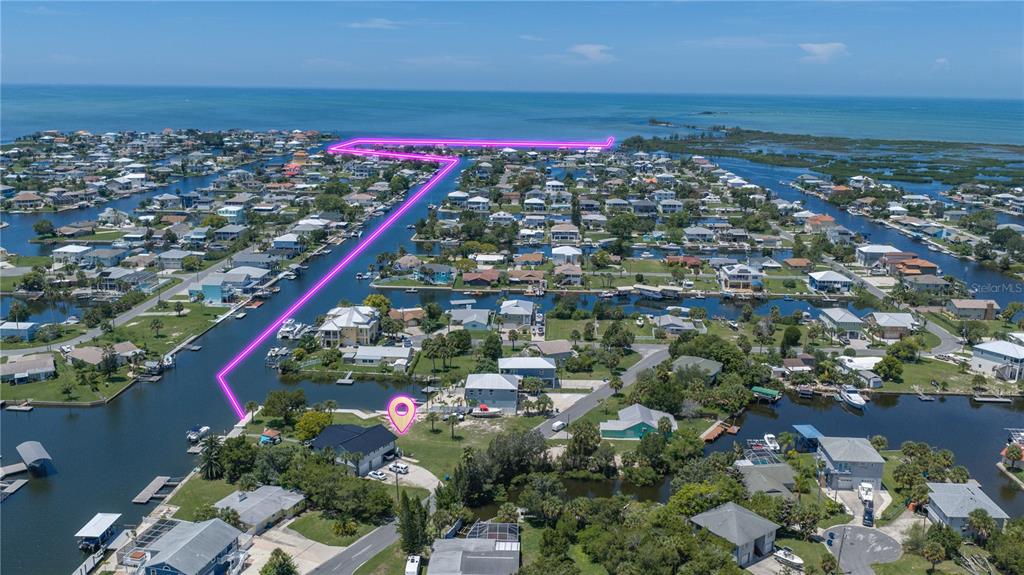 An aerial view shows a waterfront house with a highlighted property boundary near the coast — 3616 FLAMINGO BOULEVARD, HERNANDO BEACH, FL