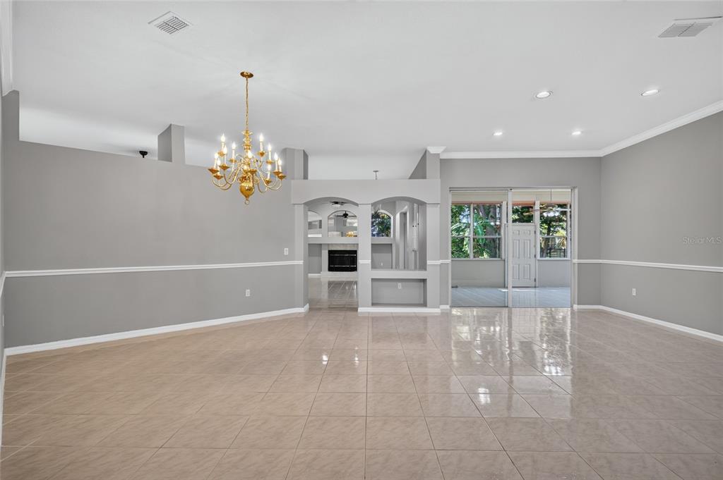 A fireplace with a black insert and gold trim sits on a tiled hearth — 2243 EAGLE BLUFF DRIVE, VALRICO, FL