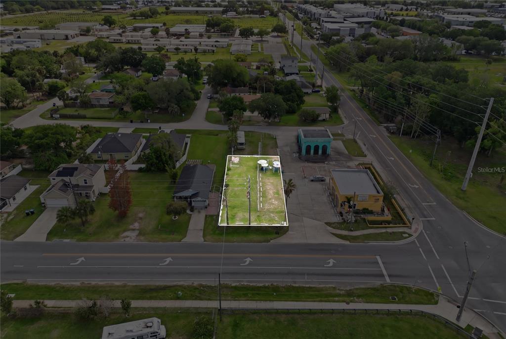 An aerial view shows a vacant, rectangular lot outlined in white between two existing buildings — 0 9TH STREET, WINTER GARDEN, FL