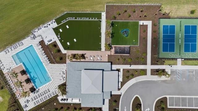 Aerial view of a community recreation center featuring a swimming pool, tennis courts, and lawn — 289 HOLLY BANK AVENUE, NOKOMIS, FL
