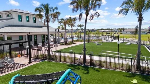 An outdoor community space features a building, palm trees, a playground, and a grassy lawn — 289 HOLLY BANK AVENUE, NOKOMIS, FL