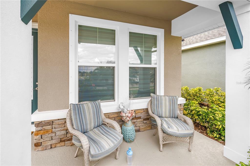 The exterior entrance features a teal front door, a welcome sign, and stone siding — 8217 TRIMBELLE, PARRISH, FL