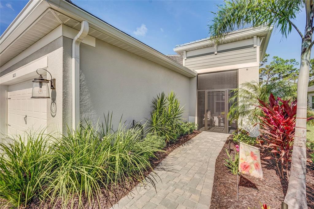 A bright hallway features tile flooring, a wooden ceiling beam, and French doors — 10233 LAKE WALES CIRCLE, SARASOTA, FL