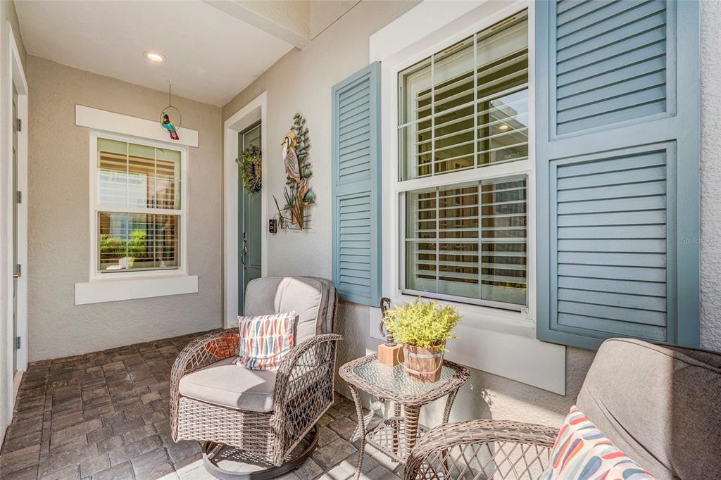 A hallway features a built-in bar, a wine cooler, and a white door with a wreath — 10233 LAKE WALES CIRCLE, SARASOTA, FL