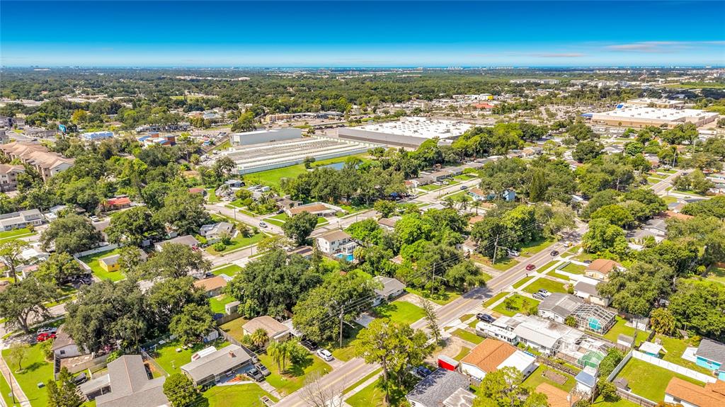 An aerial view shows a residential neighborhood with houses, trees, and a large commercial building — 6748 78TH AVENUE N, PINELLAS PARK, FL