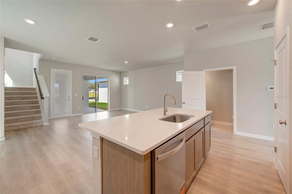 This is a digital rendering of kitchen finish samples including cabinetry, countertops, tile, and fixtures — 2823 CRIMSON CAP STREET, ODESSA, FL