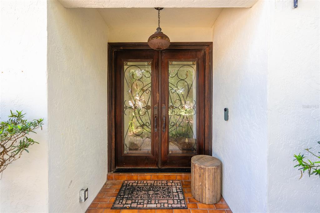 A white two-story house exterior features a brown garage door, front entryway, and landscaped yard — 40 CONCORD DRIVE, ORMOND BEACH, FL