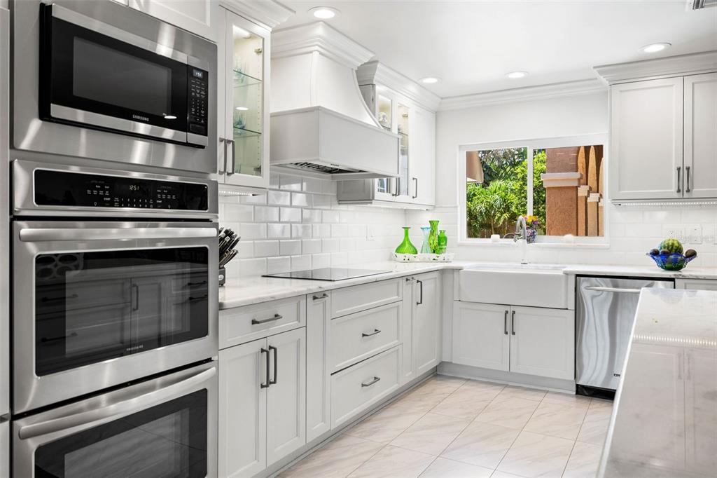 A two-story house with a pool, spa, and patio area at sunset — 1124 SEVILLE LANE NE, ST PETERSBURG, FL