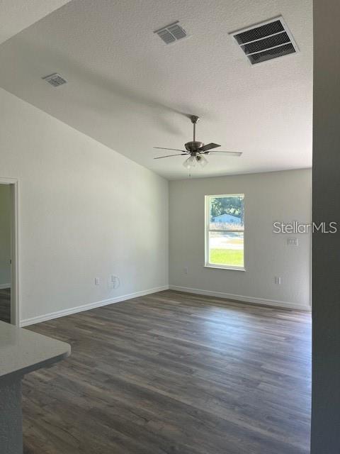 An empty room with light wood-look flooring, a ceiling fan, and a single window — 3783 SE 140TH LANE, SUMMERFIELD, FL