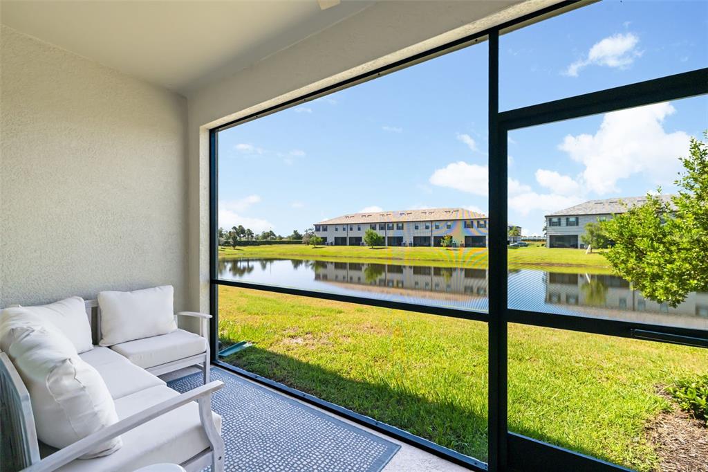 An exterior view of a home entrance featuring two dark doors and a paved porch — 15210 SUNNY DAY DRIVE, BRADENTON, FL