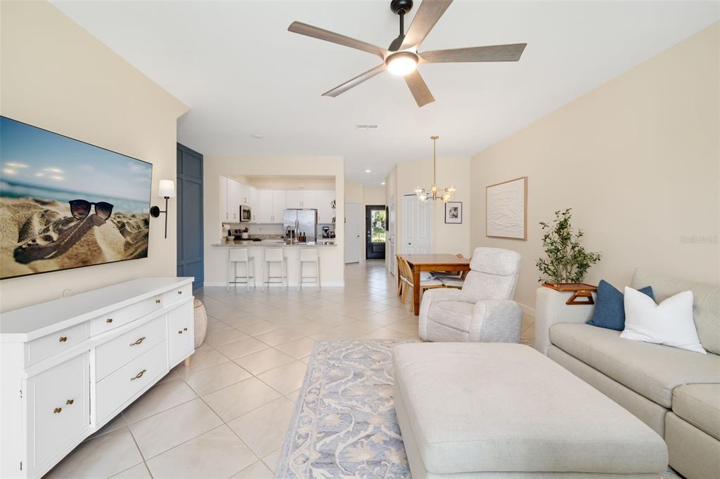 An entryway features a dark gray front door, white closet doors, and light tile flooring — 15210 SUNNY DAY DRIVE, BRADENTON, FL