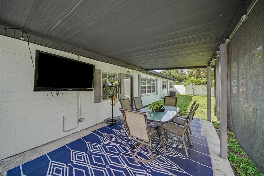 A kitchen with white cabinets, a dark countertop island, and a bench under a window — 4636 W BAY COURT AVENUE, TAMPA, FL