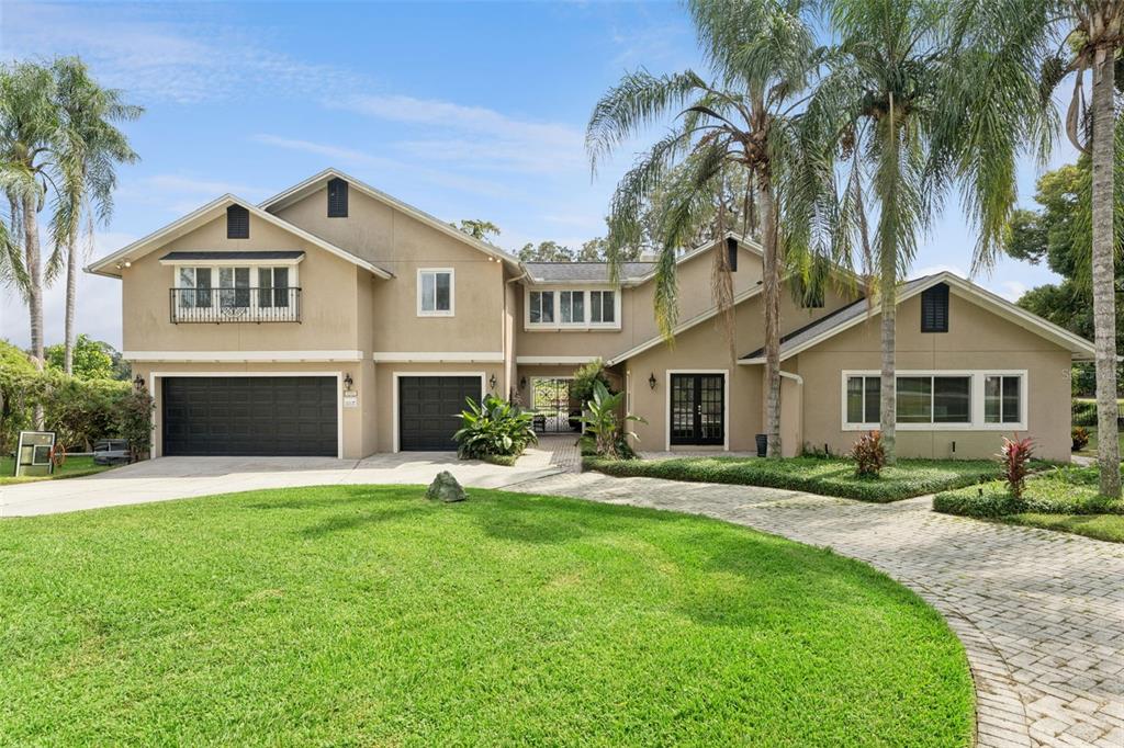 The exterior of a two-story house features a screened-in pool enclosure and a backyard swing — 4574 SAILBREEZE COURT, ORLANDO, FL
