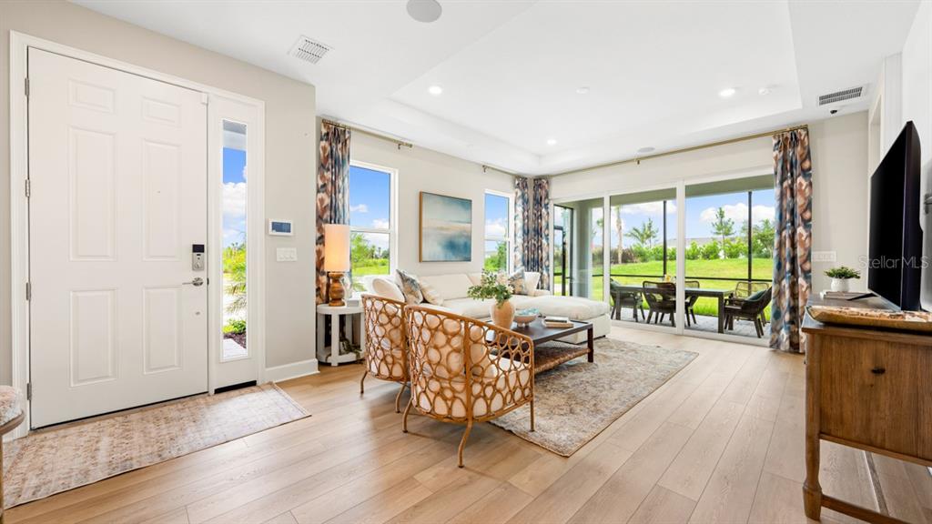 This image displays a design board featuring samples of flooring, tile, countertops, and cabinet finishes — 13336 SANTINI CIRCLE, ENGLEWOOD, FL
