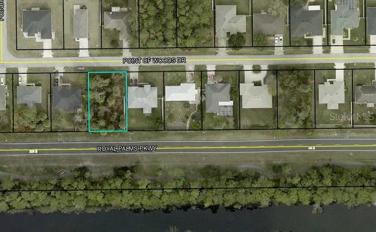 This is an aerial map showing a vacant residential lot highlighted in a suburban neighborhood — 54 POINT OF WOODS DRIVE, PALM COAST, FL