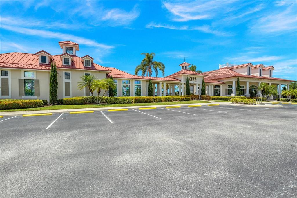 An aerial view shows a community clubhouse with a pool, tennis courts, and parking lot — 171 BLAZING STAR AVENUE, LAKE ALFRED, FL