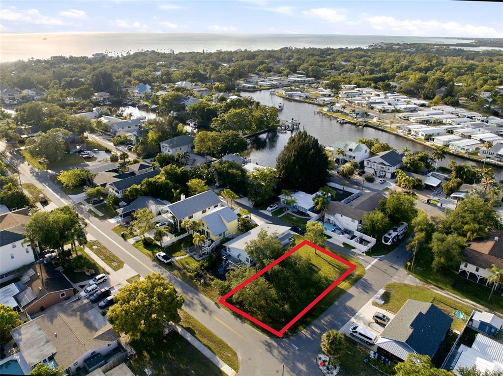An aerial view shows a vacant rectangular lot outlined in red within a residential neighborhood — 0 GEORGIA AVE. AVENUE, CRYSTAL BEACH, FL