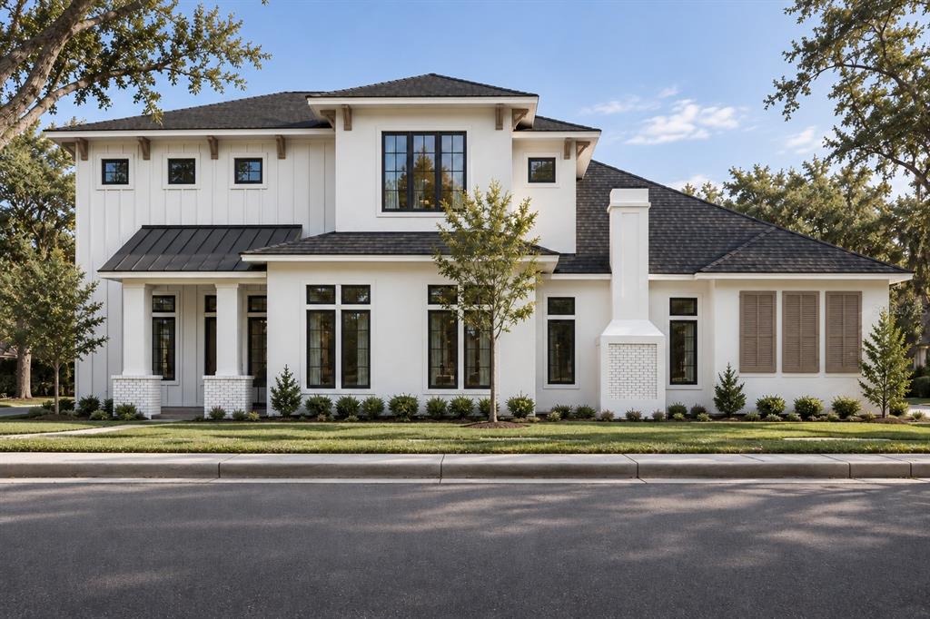 A digital rendering of a two-story white house with a dark roof and landscaping — 938 ENCLAVE PLACE, WINTER PARK, FL
