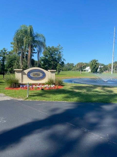 A community entrance sign stands near a pond with a fountain on a sunny day — 000 MOUNT ROYAL AVENUE, CRESCENT CITY, FL