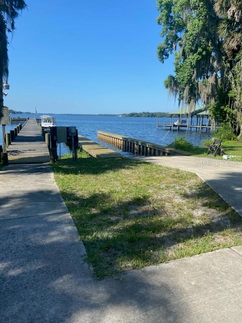 A concrete boat ramp leads to a wooden dock extending into a calm lake — 000 MOUNT ROYAL AVENUE, CRESCENT CITY, FL