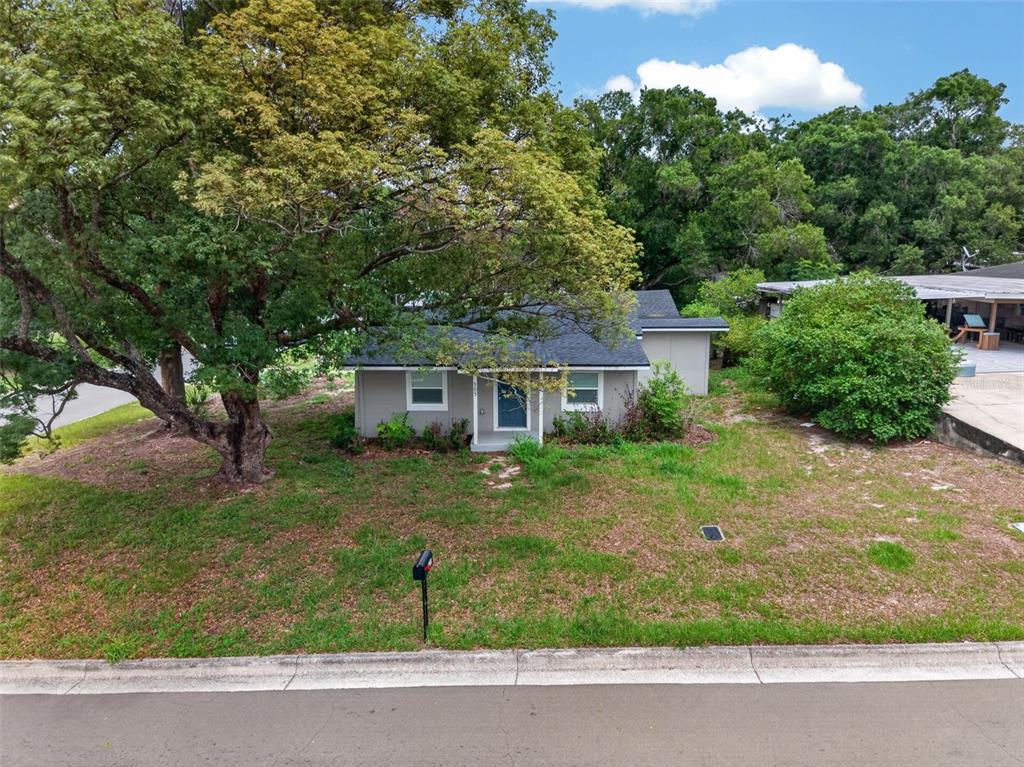 An empty room with light gray walls, wood-look flooring, a white front door, and window — 305 S SHARP STREET, LAKE WALES, FL