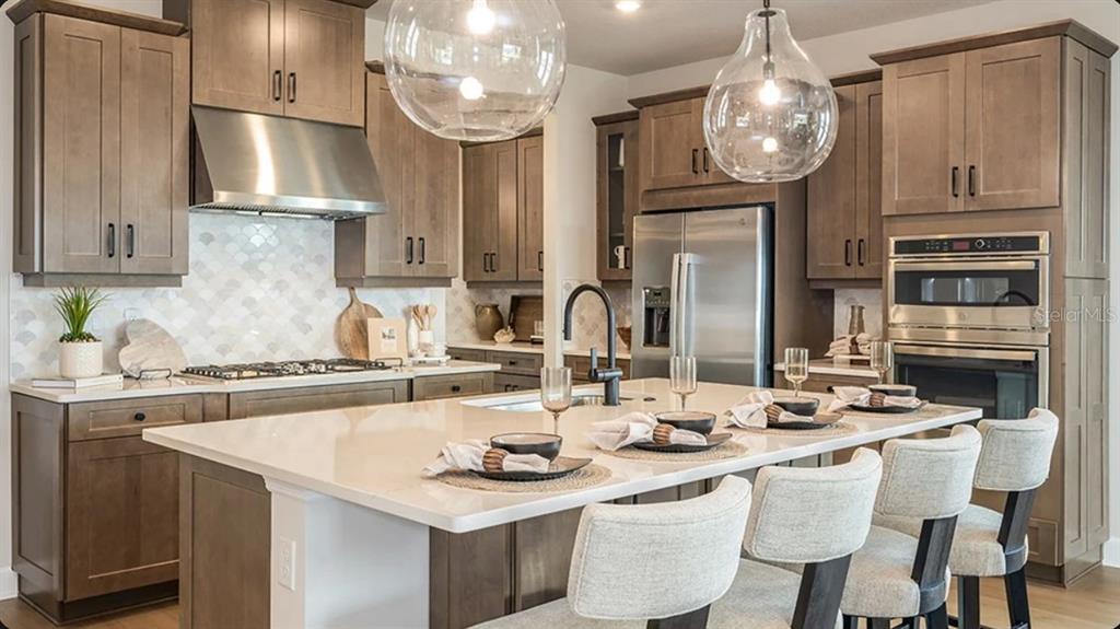 This image shows a grid of ten samples of interior finishes, including tiles and countertops — 7825 CENTAURUS WAY, SARASOTA, FL