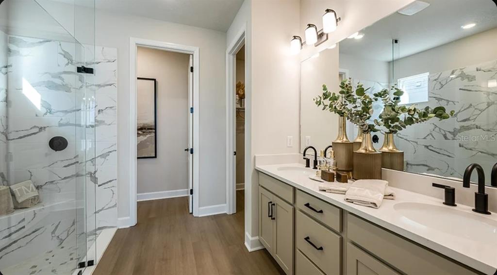 A kitchen and dining area with wood cabinets, a large island, and a dark table — 7825 CENTAURUS WAY, SARASOTA, FL
