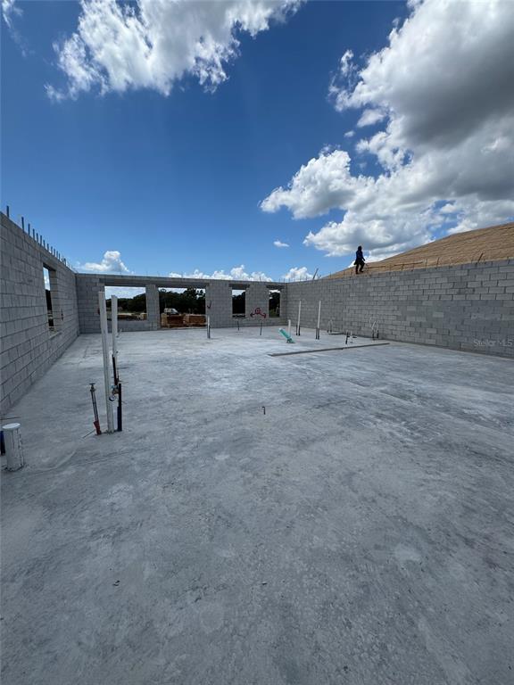 An interior view of a house under construction with concrete block walls and a slab floor — 30237 RUSTIC MILL STREET, MOUNT DORA, FL