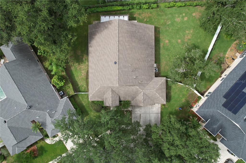 An aerial view shows a residential house with a shingled roof and a backyard — 1124 SPLIT SILK STREET, VALRICO, FL