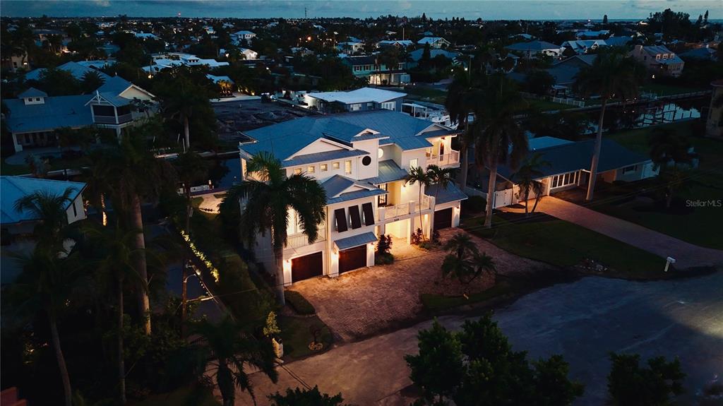 A covered balcony features a tiled floor, wooden ceiling, and double glass doors — 529 77TH STREET, HOLMES BEACH, FL