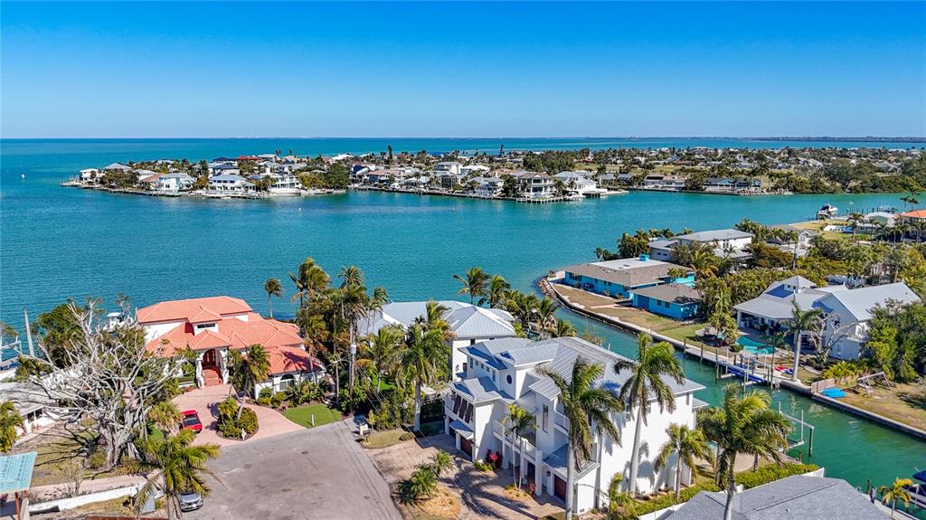 A foyer with dark wood floors, a staircase, and French doors leading to a balcony — 529 77TH STREET, HOLMES BEACH, FL