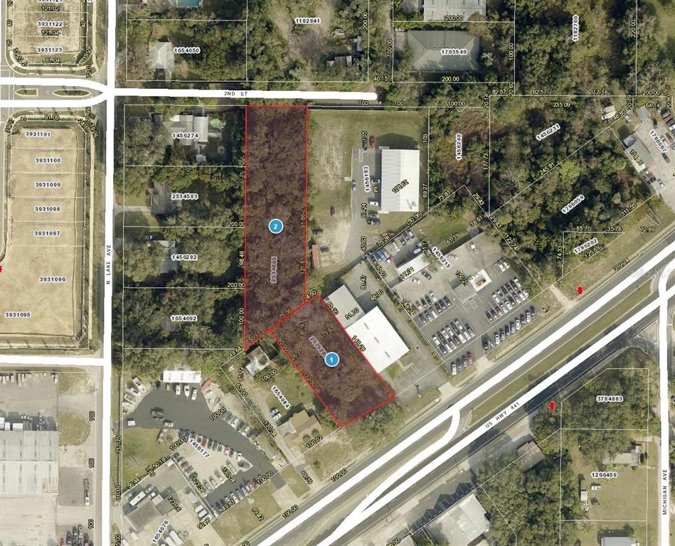 This is an aerial map showing two highlighted land parcels in a commercial area — 1602 E MAIN STREET, LEESBURG, FL