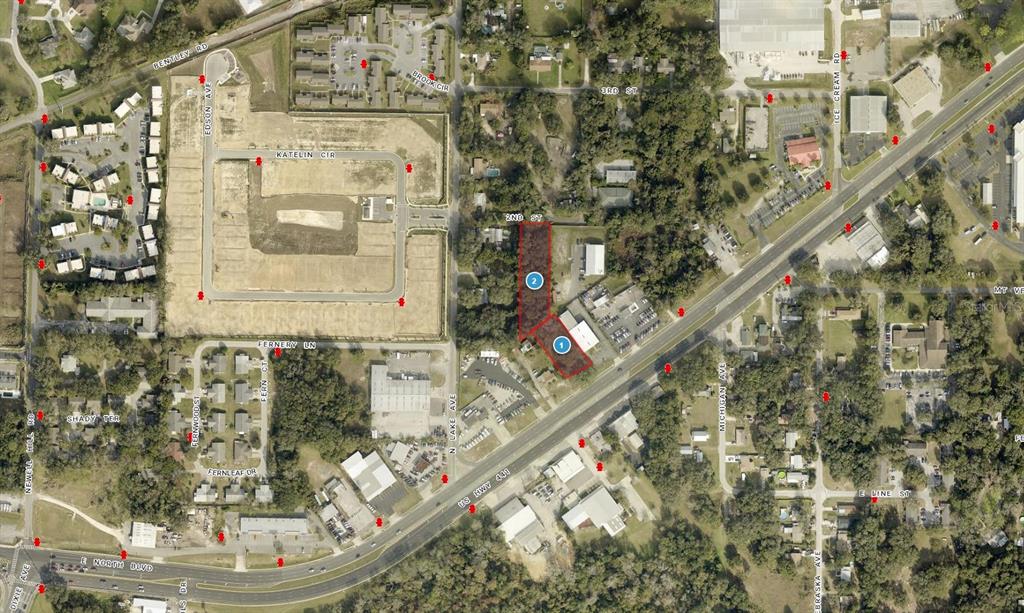An aerial map shows two highlighted adjacent land parcels located along a highway — 1602 E MAIN STREET, LEESBURG, FL
