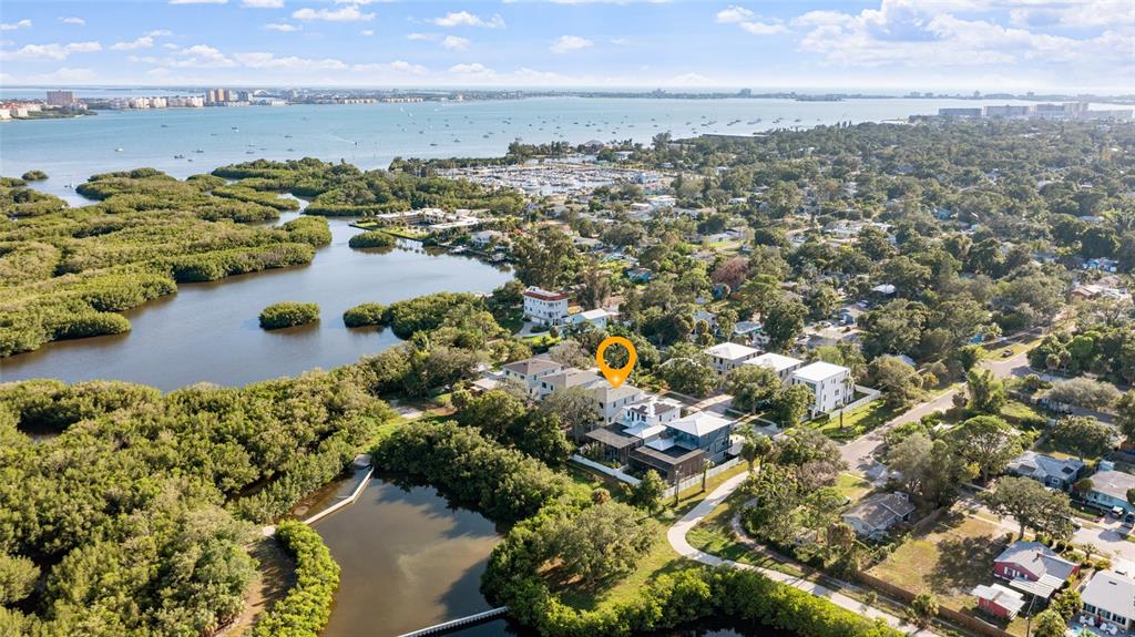 An aerial view shows a modern house with a yellow location pin near mangroves — 2614 QUINCY STREET S, GULFPORT, FL