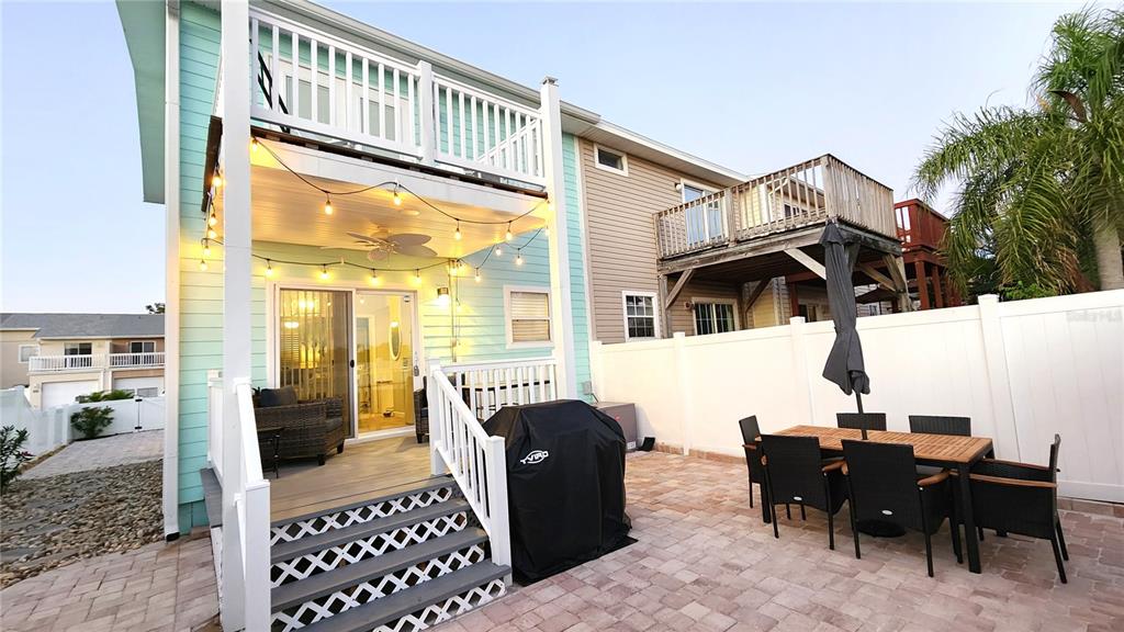 A backyard patio features a covered deck, a dining set, and a grill — 241 CHERIE DOWN LANE, CAPE CANAVERAL, FL