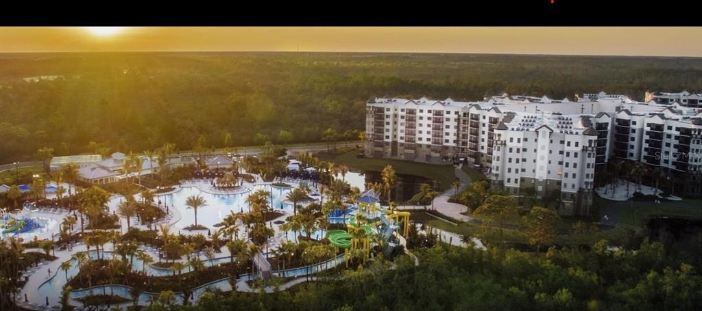 An aerial view of a large resort complex featuring a swimming pool and water slides — 14501 GROVE RESORT AVENUE UNIT 2129, WINTER GARDEN, FL