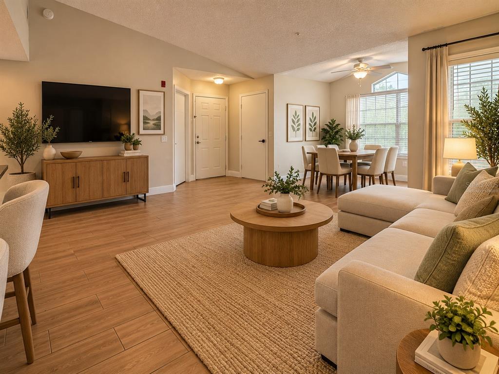An empty room features light wood-look tile flooring, vaulted ceilings, and a large window — 2216 GRAND CAYMAN COURT UNIT 1435, KISSIMMEE, FL