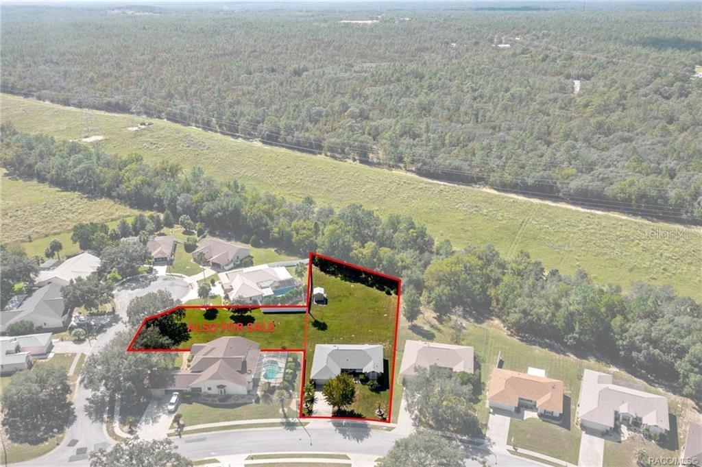 An aerial view shows a residential property with a house and a large fenced yard — 1342 S BROOKFIELD DRIVE, LECANTO, FL