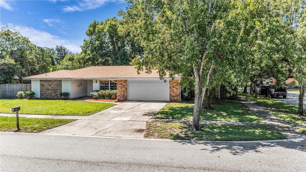 A single-story house with a brick facade, a two-car garage, and a front lawn — 8142 GOLDEN SANDS DRIVE, ORLANDO, FL