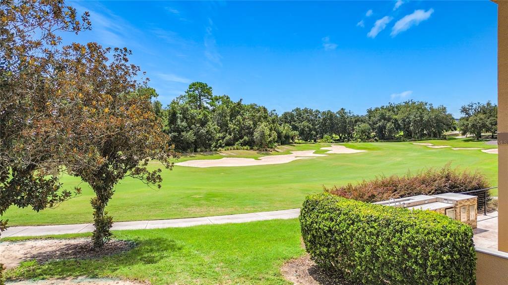 A view of a golf course fairway with sand traps from a patio area — 1221 RADIANT STREET, KISSIMMEE, FL
