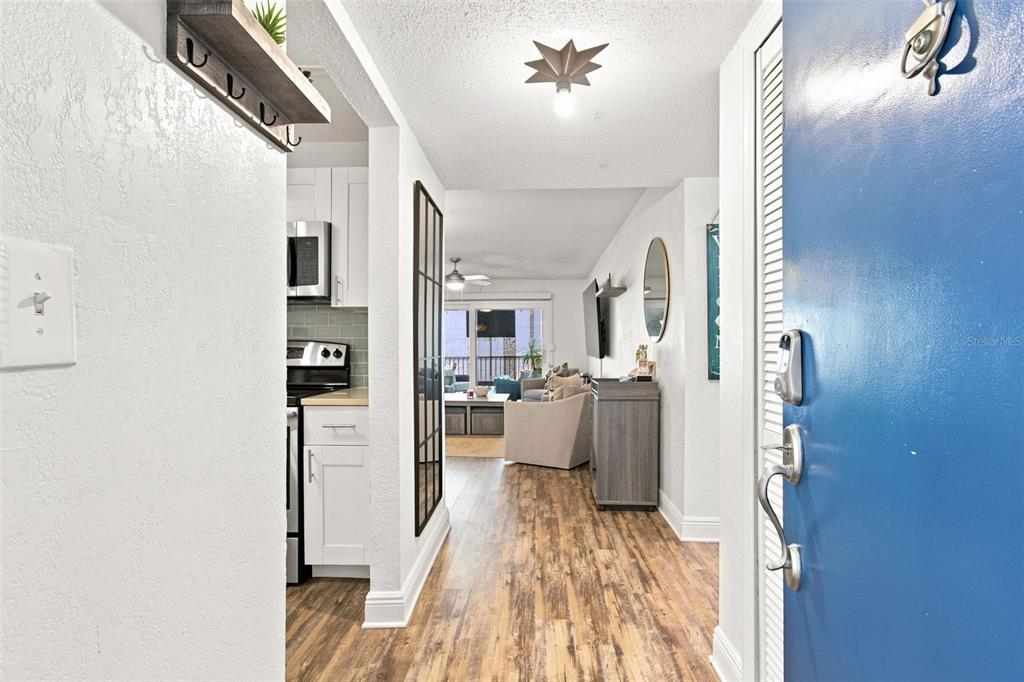 A kitchen features white cabinetry, a teal subway tile backsplash, and stainless steel appliances — 17035 GULF BOULEVARD UNIT 216, NORTH REDINGTON BEACH, FL