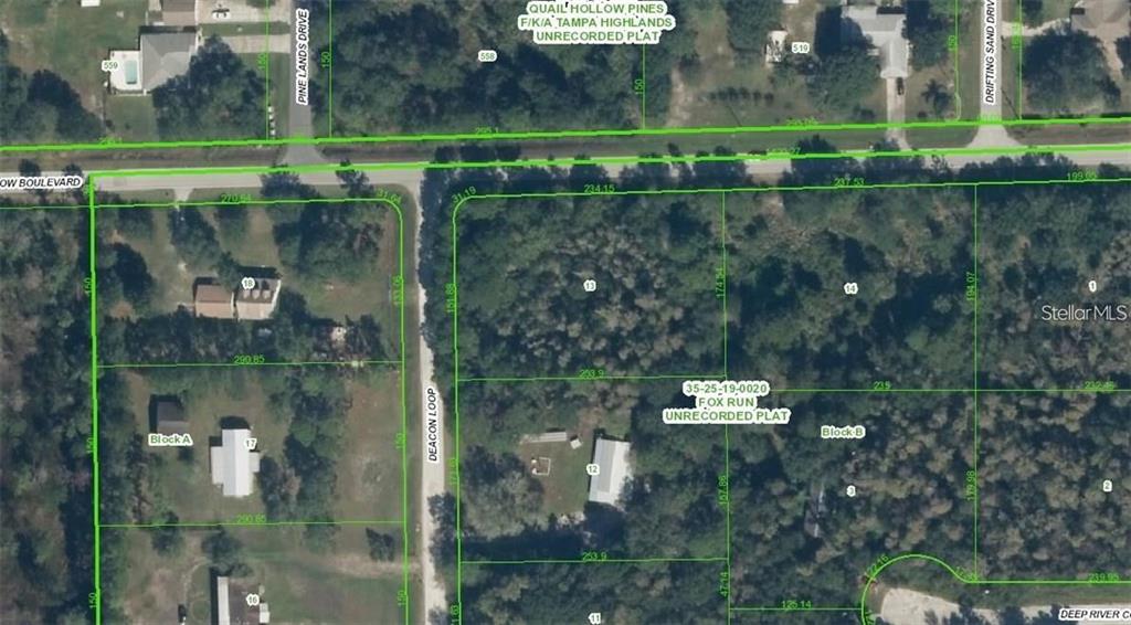 This is an aerial map showing property lot lines and parcel boundaries in a wooded area — QUAIL HOLLOW BOULEVARD, WESLEY CHAPEL,, FL