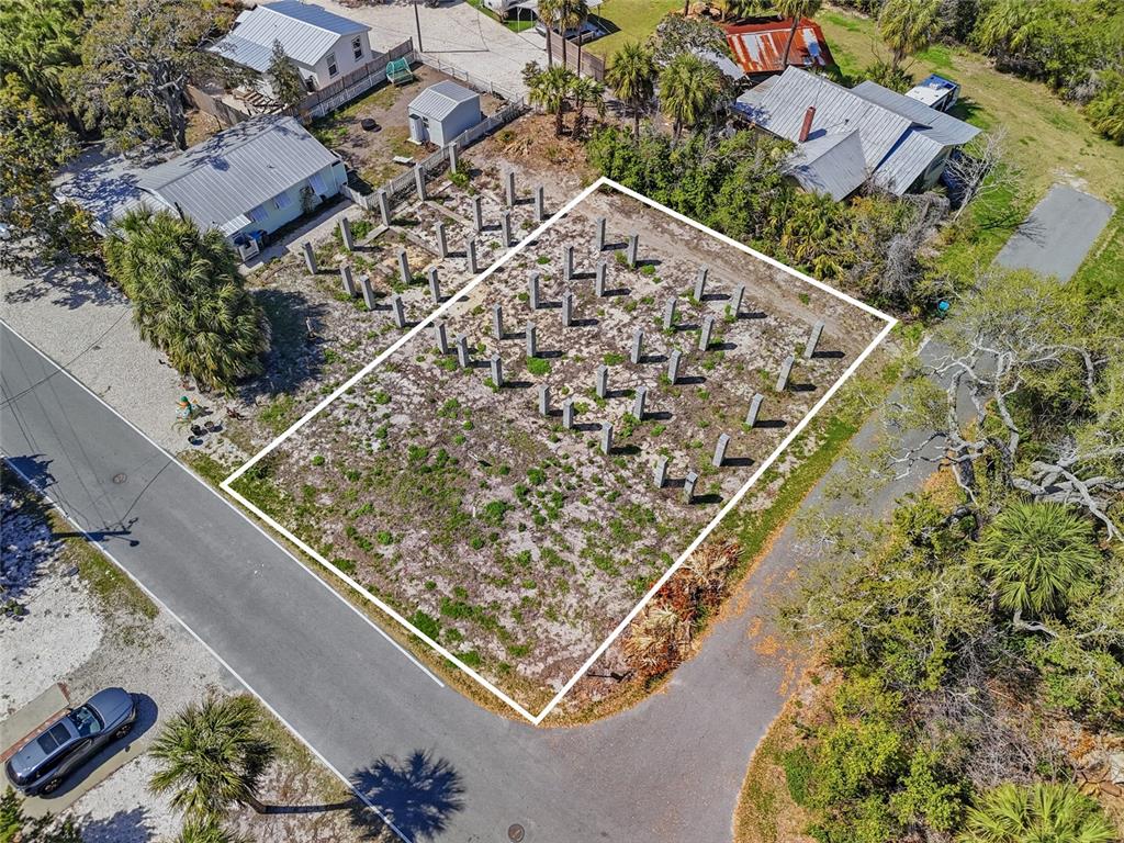 An aerial view shows a vacant lot with numerous concrete pilings installed for construction — TBD 3RD STREET, CEDAR KEY, FL